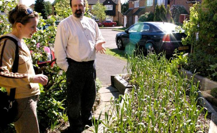 Mike Guerra explains his permaculture garden to Louise Parry