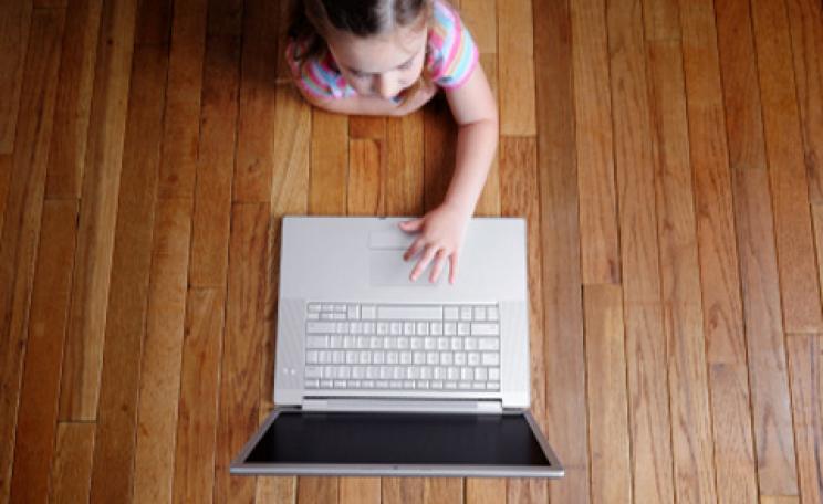 A young girl on a wireless laptop